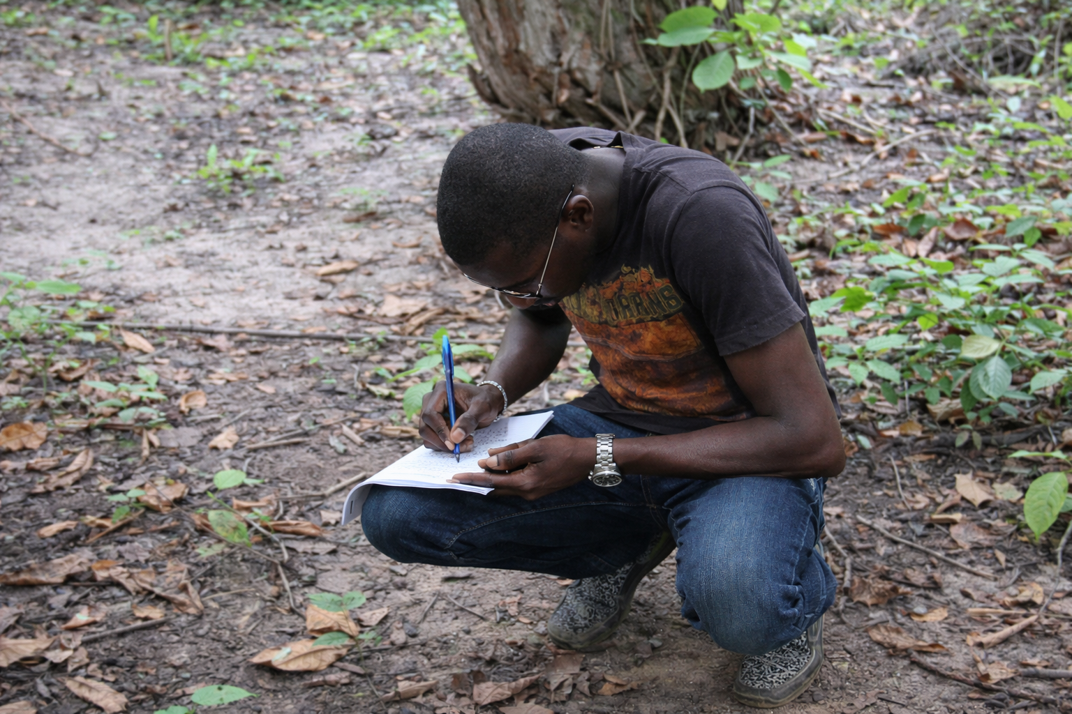 Young Man Writing In The Woods